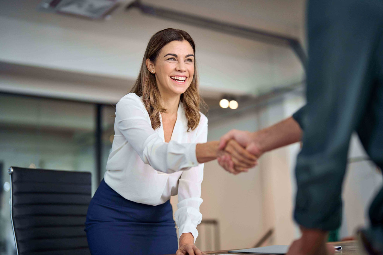 Mulher apertando a mão fechando um seguro de vida para a empresa dela